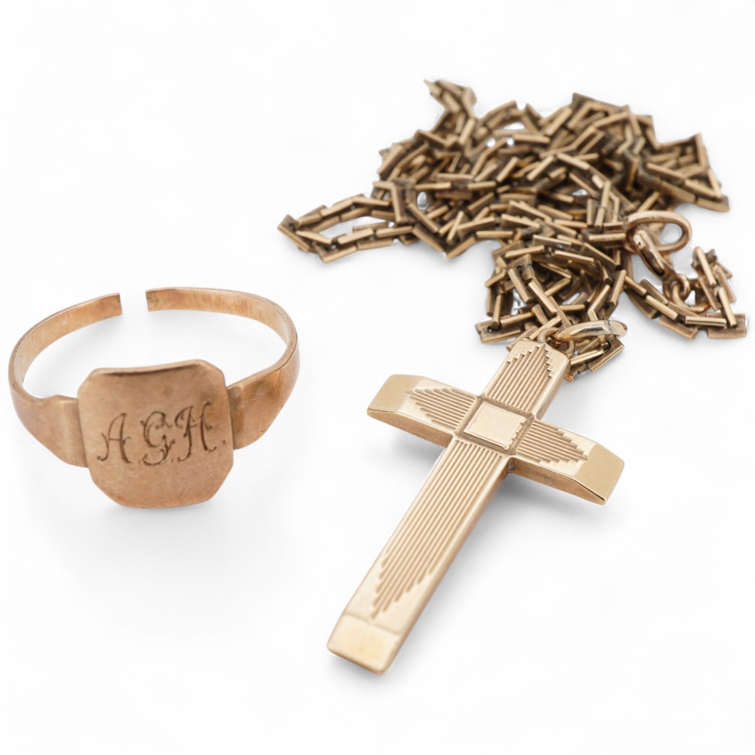 A 9ct gold cross pendant, 27mm, on a 9ct chain, 45cm and a 9ct signet ring, shank cut, 9.2 grams.